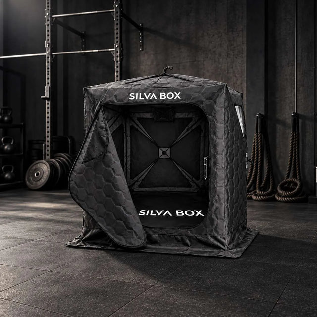 Silva Box portable infrared sauna in a dark gym with the door open